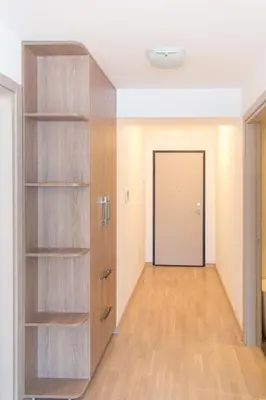 a room with a large wooden closet with a door at Mateja&Fontana Apartment in Budva