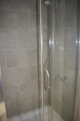 a shower stall with a glass door in a bathroom at Mateja&Fontana Apartment in Budva