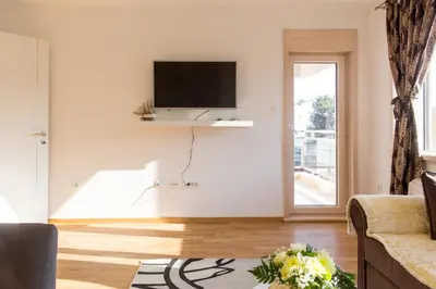 a living room with a flat screen tv on the wall at Mateja&Fontana Apartment in Budva