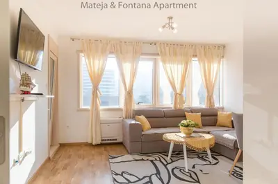 a living room with a couch and a table at Mateja&Fontana Apartment in Budva