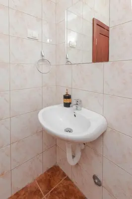 a bathroom with a white sink and a mirror at Guest house Vila Vedesa in Kotor