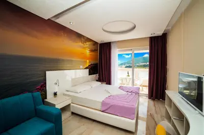 a bedroom with a bed and a view of the ocean at Ponta in Rafailovici