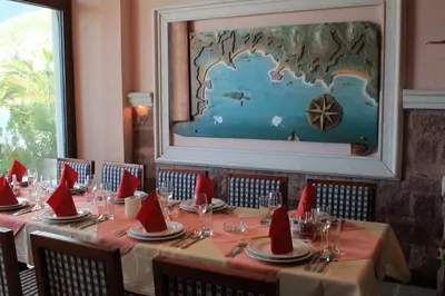a table with red napkins on it in a restaurant at Ponta in Rafailovici