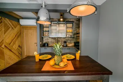 a kitchen with a wooden table with fruit on it at Apartments Magic Sea View in Kotor