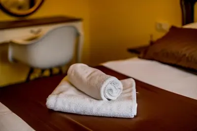 a rolled up towel sitting on a table in a hotel room at Apartments Magic Sea View in Kotor