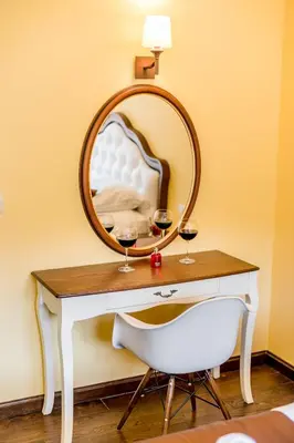 a table with a mirror and two glasses of wine at Apartments Magic Sea View in Kotor