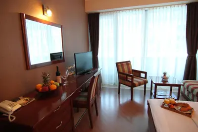 a living room with a television and a table with fruit on it at Accommodation Dolcino in Ulcinj