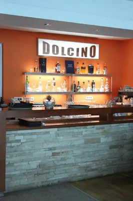 a restaurant with a counter with a sign that reads dotto at Accommodation Dolcino in Ulcinj
