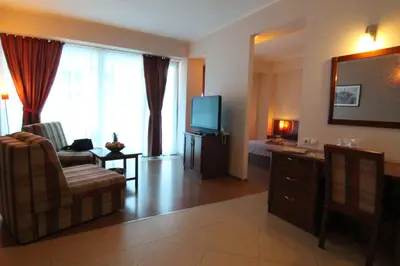 a living room with a television and a couch and a chair at Accommodation Dolcino in Ulcinj