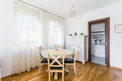 a dining room with a table and chairs at Apartments LORA Cetinjska in Budva