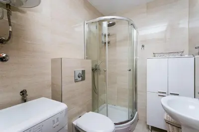 a bathroom with a shower and a toilet and a sink at Apartments LORA Cetinjska in Budva