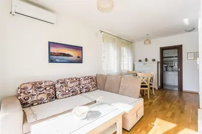 a living room with a couch and a table at Apartments LORA Cetinjska in Budva