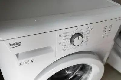 a white washing machine with its door open at Apartments LORA Cetinjska in Budva