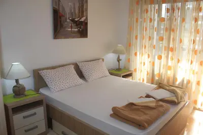 a bedroom with a bed with two towels on it at Pjerotic Apartment in Budva