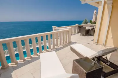 a balcony with chairs and a view of the ocean at Luxury Villa Alena in Utjeha
