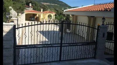 a black gate in front of a house at Luxury Villa Alena in Utjeha