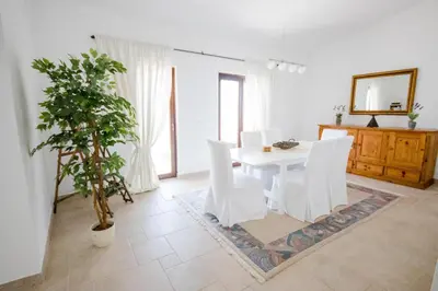 a white dining room with a table and a potted plant at Luxury Villa Alena in Utjeha