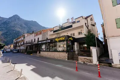 a street with a store on the side of a building at Bofima Apartments in Kotor