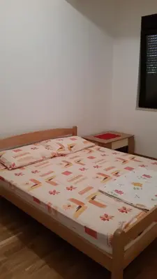 a bed sitting in a room with at M&M Apartman 2 in Rafailovici