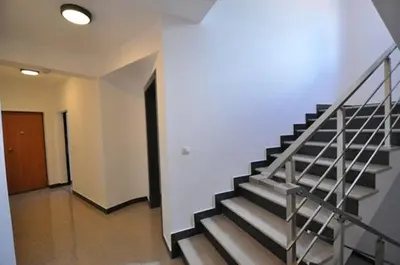 a hallway with a staircase in a building at M&M Apartman 2 in Rafailovici