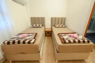 two beds sitting next to each other in a room at Hostel Izvor in Podgorica