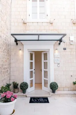 a door to a building with a black awning at La Villa Boutique Hotel in Budva
