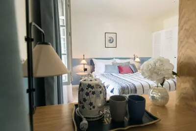 a bedroom with a bed and a table with a vase at La Villa Boutique Hotel in Budva