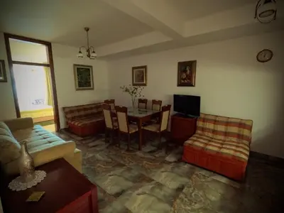 a living room with a table and a dining room at Olga Bashinskaya in Sutomore