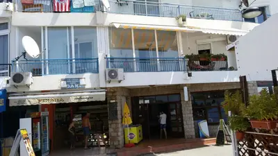 a building with a balcony and people standing outside at Olga Bashinskaya in Sutomore