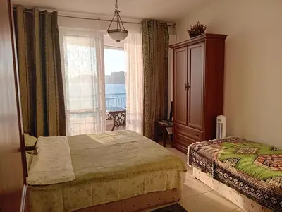 a bedroom with a bed and a window at Olga Bashinskaya in Sutomore