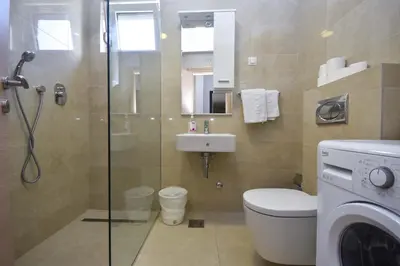 a bathroom with a shower toilet and a sink at Apartment Bojana in Budva