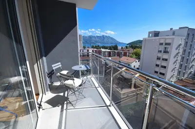 a balcony with chairs and a view of a city at Apartment Bojana in Budva