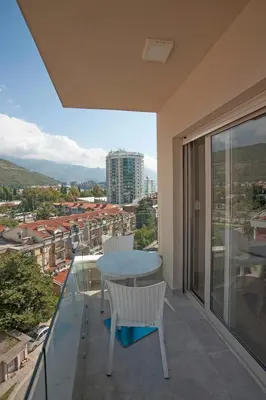 a balcony with a table and chairs and a view at JK Suites in Budva