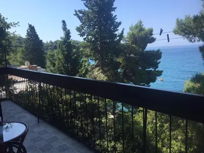 a balcony with a view of the ocean at Apartment Botanicheskiy Sad in Sutomore