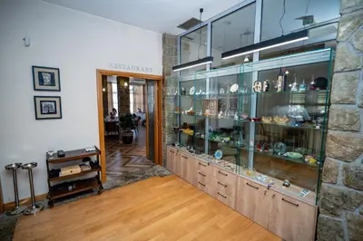 a room with a glass display case in a building at Hotel Aria in Podgorica