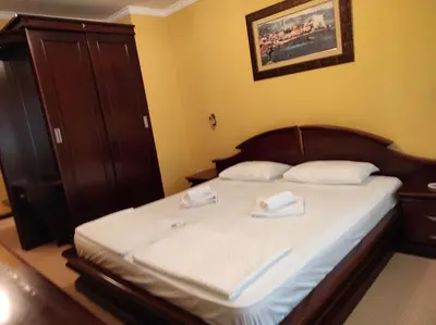 a bedroom with a bed with two towels on it at Hotel Mimoza in Budva