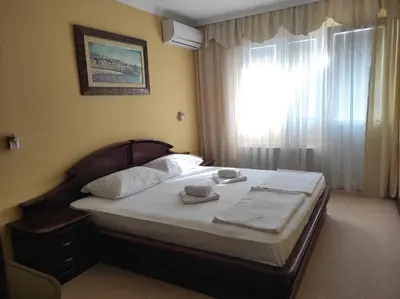 a bed in a hotel room with a window at Hotel Mimoza in Budva
