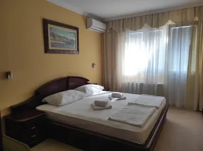 a bed in a hotel room with a window at Hotel Mimoza in Budva
