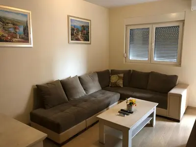 a living room with a couch and a coffee table at Apartments New City in Podgorica