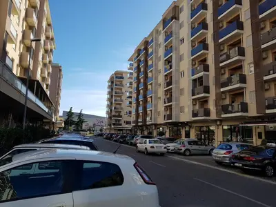 a city street with cars parked in a parking lot at Apartments New City in Podgorica