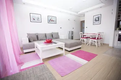 a living room with a couch and a table at Sea view Apartments Panorama Przno in Sveti Stefan