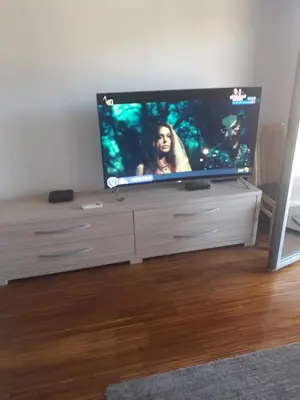 a flat screen tv sitting on top of a entertainment center at Sea view Apartments Panorama Przno in Sveti Stefan