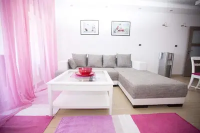 a living room with a bed and a table at Sea view Apartments Panorama Przno in Sveti Stefan