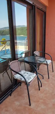 a table and chairs on a balcony with a view of the water at Apartment Sea Space 2 in Dobra Voda