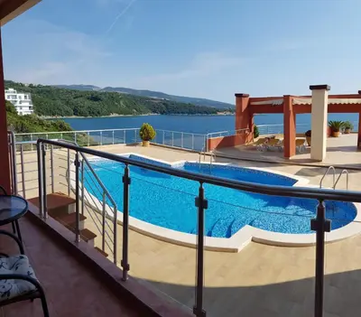 a swimming pool on a balcony with a view of the water at Apartment Sea Space 2 in Dobra Voda