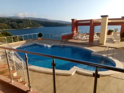 a swimming pool on a balcony with a view of the water at Apartment Sea Space 2 in Dobra Voda