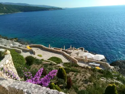 a view of a body of water with purple flowers at Apartment Sea Space 3 in Dobra Voda