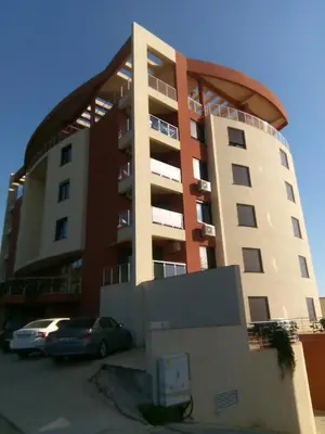a building with a car parked in front of it at Apartment Sea Space 3 in Dobra Voda