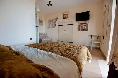 a bedroom with a bed and a flat screen tv at Medin di Lastua in Petrovac na Moru