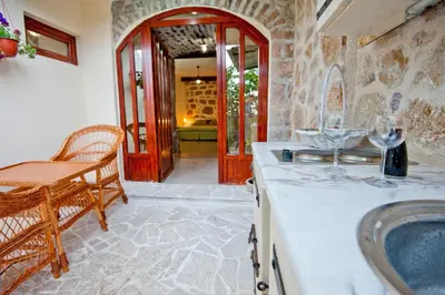 a kitchen with a counter with wine glasses on it at Medin di Lastua in Petrovac na Moru